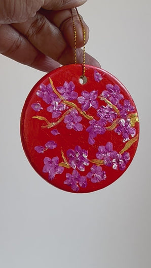 Hand painted orange Christmas ornament wit pink cherry blossoms