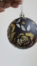 Load and play video in Gallery viewer, Gold Floral artwork on black Christmas ornament
