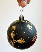 Load image into Gallery viewer, Black Gold and white holly leaves and berries artwork on Christmas ornament 
